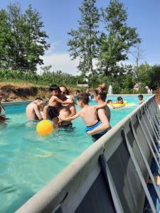 a group of people playing in a swimming pool at Pensiunea Valea Badilii in Valea Iasului