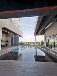 a swimming pool in the middle of a building at Little Deer Homestay in Kota Bharu