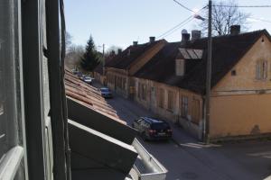 a view from a window of a city street with cars at Skrundas ielas apartamenti in Kuldīga +5 photos