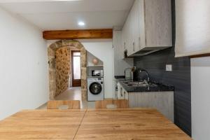 a kitchen with a large wooden table in a room at Les Gubies in Beceite