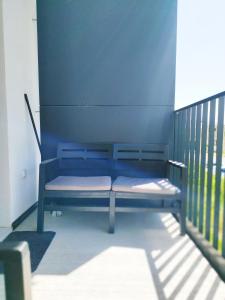 a blue bench sitting on top of a balcony at Prechodná stanica in Brezno