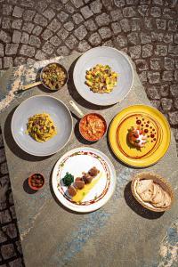 a table with plates of food on it at Agriturismo La Cerra in Tivoli