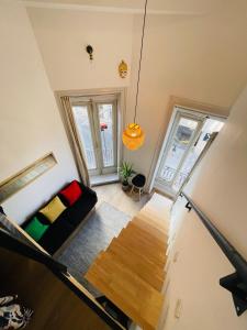 un soggiorno con un divano e due finestre di Magnifique Loft sur 2 niveaux Comédie Gare a Montpellier