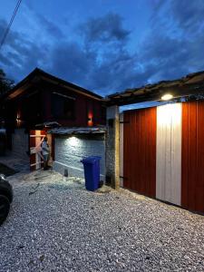 a woman sitting in front of a house at Ethno Villa Cherry in Cherven +4 photos