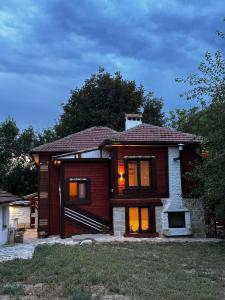 a house with its lights on in the yard at Ethno Villa Cherry in Cherven