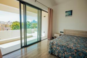 una camera da letto con un letto e una grande finestra di Two Villas a Tamarin