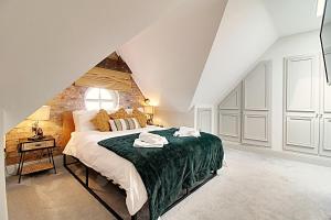 a bedroom with a large bed in a attic at Finest Retreats - Highfield House in Ripon