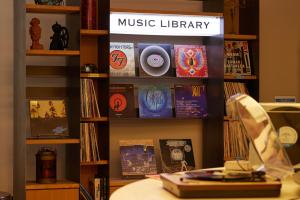 a book shelf with music library signs on it at Kobe Motomachi Tokyu REI Hotel in Kobe