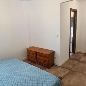 a bedroom with a bed and a dresser and a mirror at Duquesa Harbour Club Aparthotel in Manilva