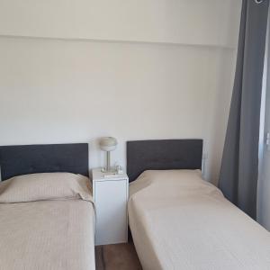 two beds sitting next to each other in a room at Duquesa Harbour Club Aparthotel in Manilva