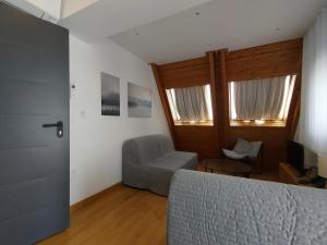 a living room with a couch and a chair at Marelia Urban in Thessaloniki