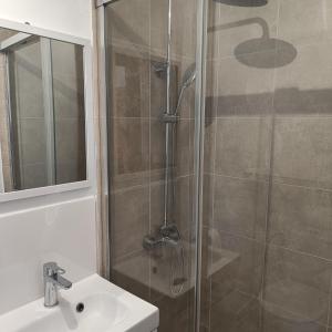 a bathroom with a shower and a sink at Duquesa Harbour Club Aparthotel in Manilva