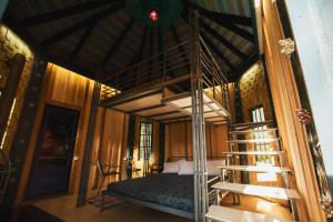 a bedroom with a bunk bed in a room with a ladder at Vytenio parkas in Sudervė