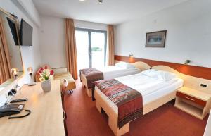 Postel nebo postele na pokoji v ubytování Hotel Krek Superior