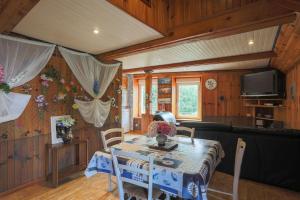 a living room with a table and a couch at Maison Bateau in Plouézec