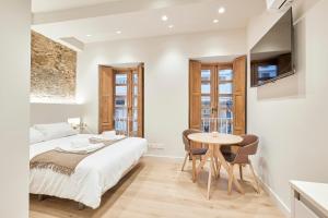 a bedroom with a bed and a table and chairs at Casa Beltane in A Coruña