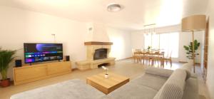 a living room with a couch and a fireplace at Belle maison, 15mn de Paris, 2 parkings gratuits in Cachan