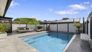 a swimming pool in the backyard of a house at Ellie's Holiday Escape - Pool, Romantic, Fireplace in Coffs Harbour
