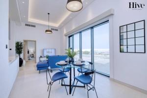 a dining room with a blue table and blue chairs at 7 by Aurora 211 in Dubai
