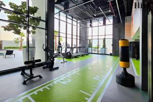 a gym with treadmills and exercise equipment in a building at 7 by Aurora 211 in Dubai