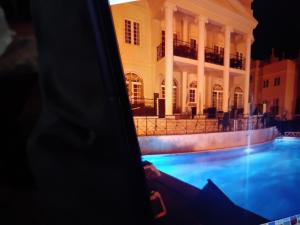 a view of a building with a swimming pool at night at Nice flat in pretty condo in Quarteira