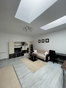 a white living room with a couch and a table at Enjoy Apartments - Central Skylight Residence in Cluj-Napoca +10 photos