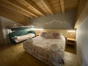 Postel nebo postele na pokoji v ubytování Hotel Sciatori 3 Stelle Superior