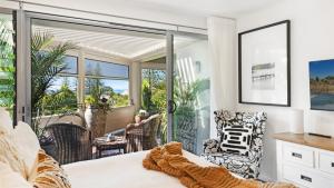 a bedroom with a bed and a balcony at Pearl - Resort Pool, Tennis Courts, Beach Front in Sapphire Beach