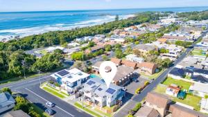 an aerial view of a town with the ocean at Seas the Day - Modern Townhouse in Sawtell Village in Sawtell