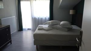 a bedroom with a bed with pillows and a window at EdMont in Pietroşiţa +65 photos