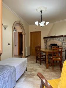 a bedroom with a bed and a table and a fireplace at Il borgo di Mefila, La casa in Corte in Scandriglia +10 photos