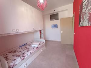 a small room with a bed and a red wall at Da Nonna Melina by Holiday World in Licata