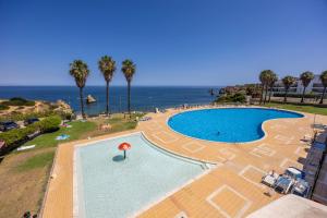a swimming pool with a view of the ocean at O Golfinho in Lagos