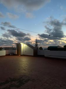 a building with a bird flying in the sky at Logement bord de mer in El Harhoura