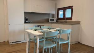 a kitchen with a table and chairs in a kitchen at AQUAGARDEN Short Lets in Polignano a Mare