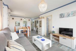 a living room with a couch and a table at Apartamentos El Puerto, La Savina in La Savina