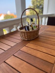 a basket of wine bottles sitting on a table at Apartment w/ spacious terrace in Mandre +22 photos