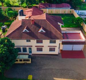 an overhead view of a white house with a red roof at Karibu Nyumbani Hostel in Sokon
