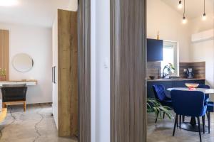 a kitchen and dining room with a table and chairs at PERLA VERDE Apartments in Krk