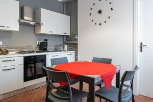 a kitchen with a table with a red table cloth on it at La Casina in Foiano della Chiana