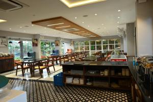 a restaurant with wooden tables and chairs in a room at Krishna Riverside Resort in Vasad