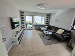 a living room with a couch and a table at Ferienwohnung Karlson in Wilhelmshaven