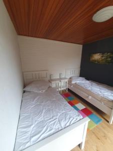 a bedroom with two beds and a wooden ceiling at CrisAnd 5 Anjofina in Altenau +22 photos