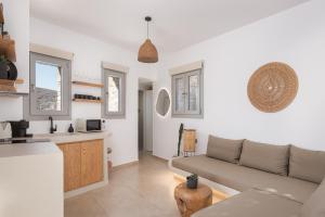 a living room with a couch and a kitchen at Rabela's in Kollimpithra