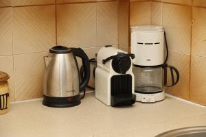 a kitchen counter with various appliances on a counter top at Aira Apartments in Azolimnos Syros
