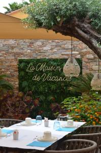 a table with a sign that says la museum of volcanoes at Le Mouillage in Saint-Tropez