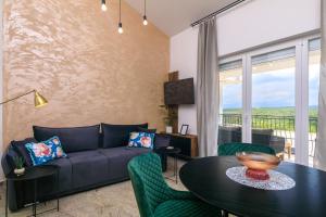 a living room with a couch and a table at PERLA VERDE Apartments in Krk