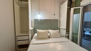 a bedroom with a bed with two pillows and a mirror at Estudio de Mia in Cádiz