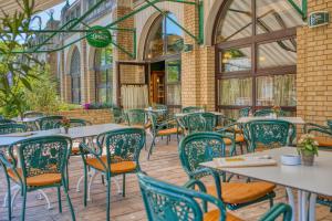 an empty restaurant with tables and chairs at Ensana Grand Margaret Island in Budapest