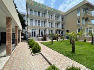 a large building with a lawn in front of it at KARD HOUSE in Kobuleti